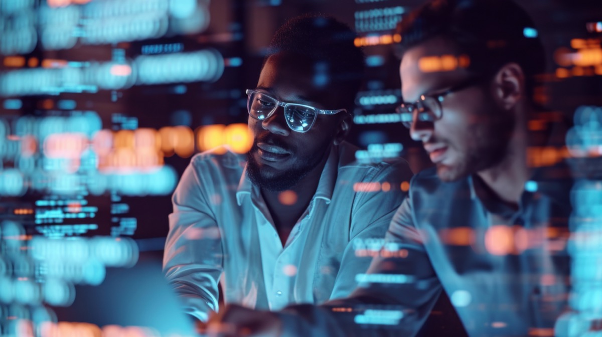 two handsome businessman working in the office superimposed over multiple lines of computer code digital proficiency gap