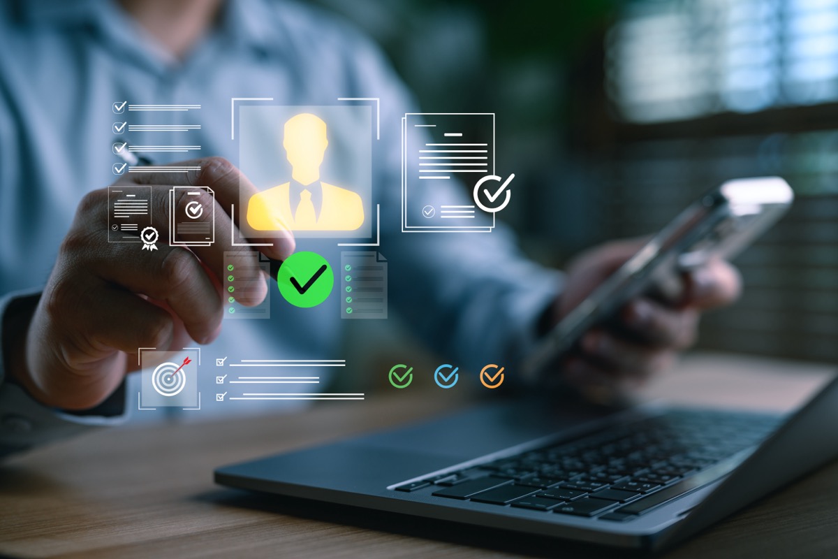 A businessman using smart technology to verify digital identity, KYC documents, and approve online profiles, representing secure authentication and onboarding in digital business platforms. Image of person using structured approach for contingent workforce management to include SOC 2 in talent acquisition.