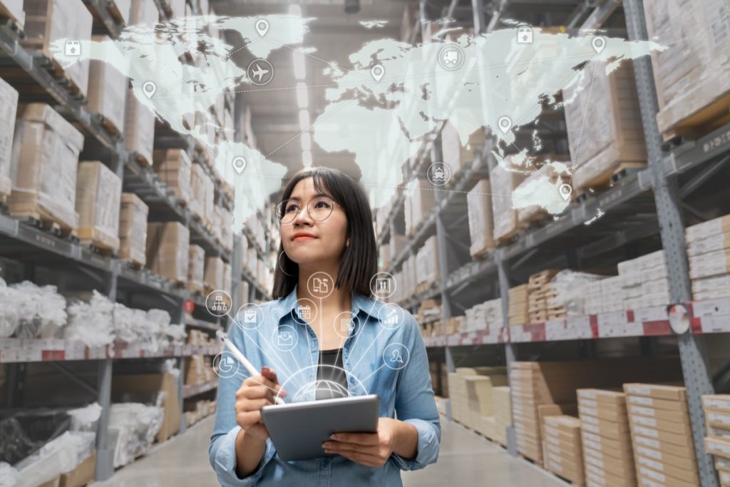 Portrait of procurement specialist looking at inventory in warehouse using smart tablet in management technology,  interconnected industry, and enterprise business concept.